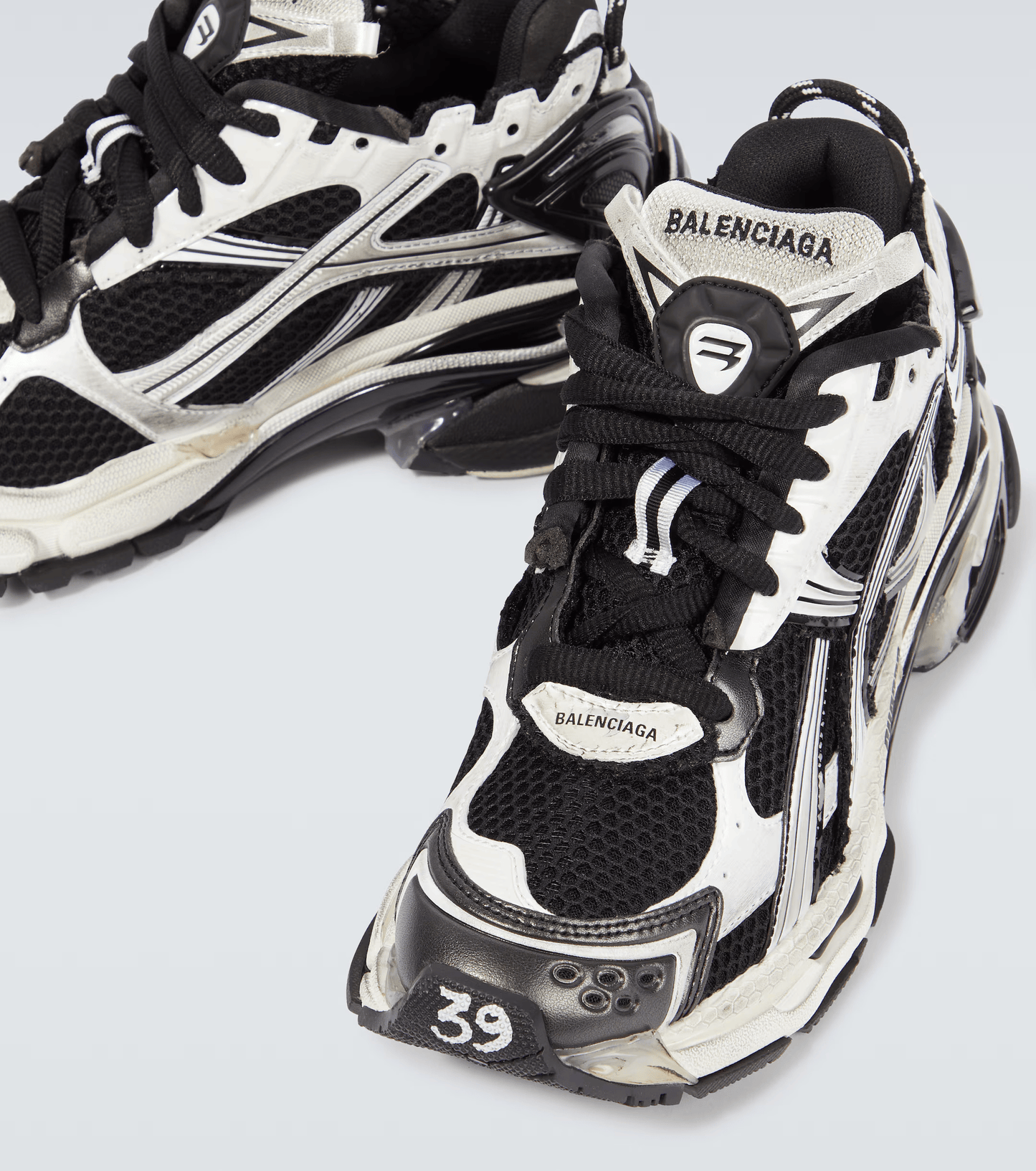 distressed white & black mesh runner sneakers
vintage luxury style running shoes
grey deconstructed street sneakers
balenciaga inspired runners