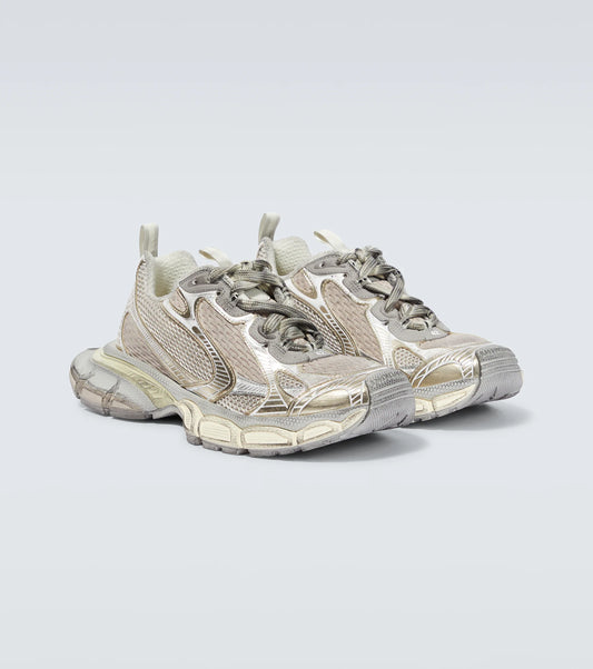 white & gold 3XL oversized sneakers

chunky brutalist sneakers with mesh upper

trail running inspired tech footwear

balenciaga style extra large sneakers