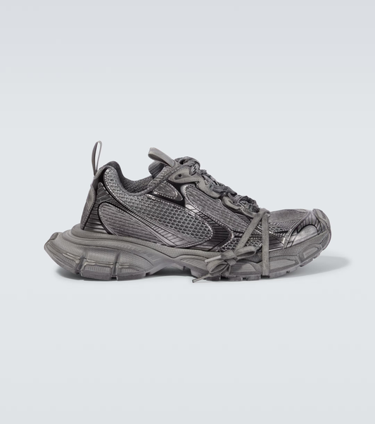 dark gray 3XL oversized sneakers

chunky brutalist sneakers with mesh upper

trail running inspired tech footwear

balenciaga style extra large sneakers