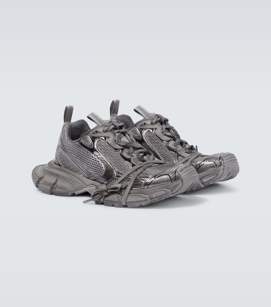 dark gray 3XL oversized sneakers

chunky brutalist sneakers with mesh upper

trail running inspired tech footwear

balenciaga style extra large sneakers