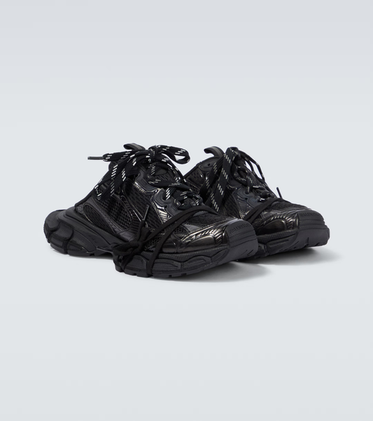black 3XL Mule oversized sneakers

chunky brutalist sneakers with mesh upper

trail running inspired tech footwear

balenciaga style extra large sneakers