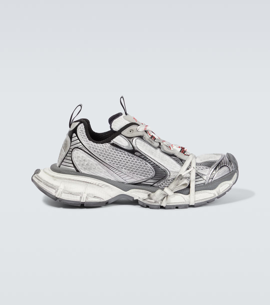 white, black & red 3XL oversized sneakers

chunky brutalist sneakers with mesh upper

trail running inspired tech footwear

balenciaga style extra large sneakers