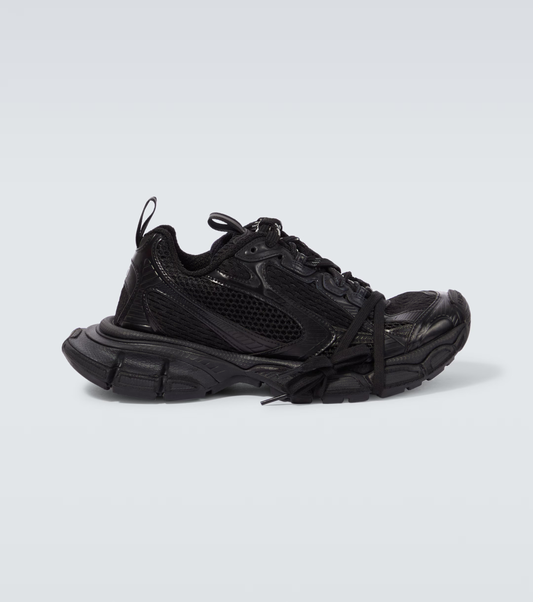 all black 3XL oversized sneakers

chunky brutalist sneakers with mesh upper

trail running inspired tech footwear

balenciaga style extra large sneakers
