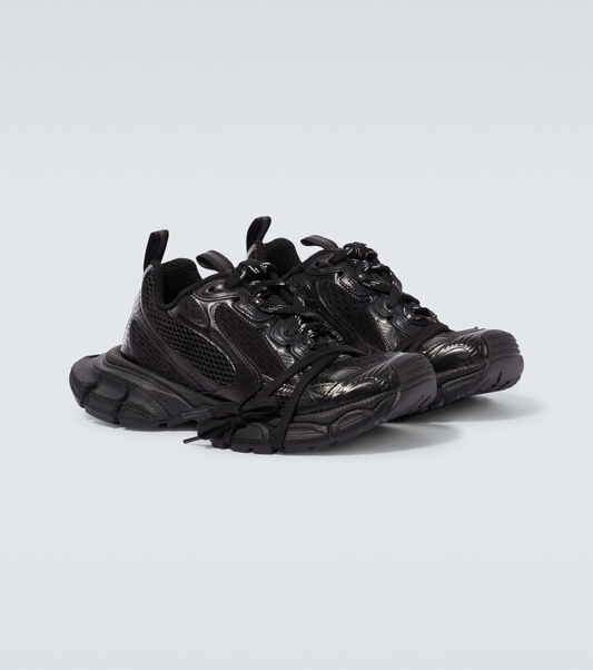 all black 3XL oversized sneakers

chunky brutalist sneakers with mesh upper

trail running inspired tech footwear

balenciaga style extra large sneakers