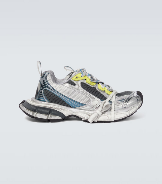 white-black-blue-yellow 3XL oversized sneakers

chunky brutalist sneakers with mesh upper

trail running inspired tech footwear

balenciaga style extra large sneakers