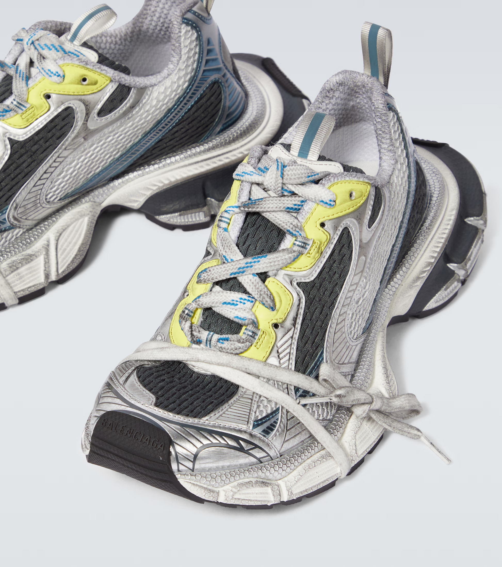 white-black-blue-yellow 3XL oversized sneakers

chunky brutalist sneakers with mesh upper

trail running inspired tech footwear

balenciaga style extra large sneakers