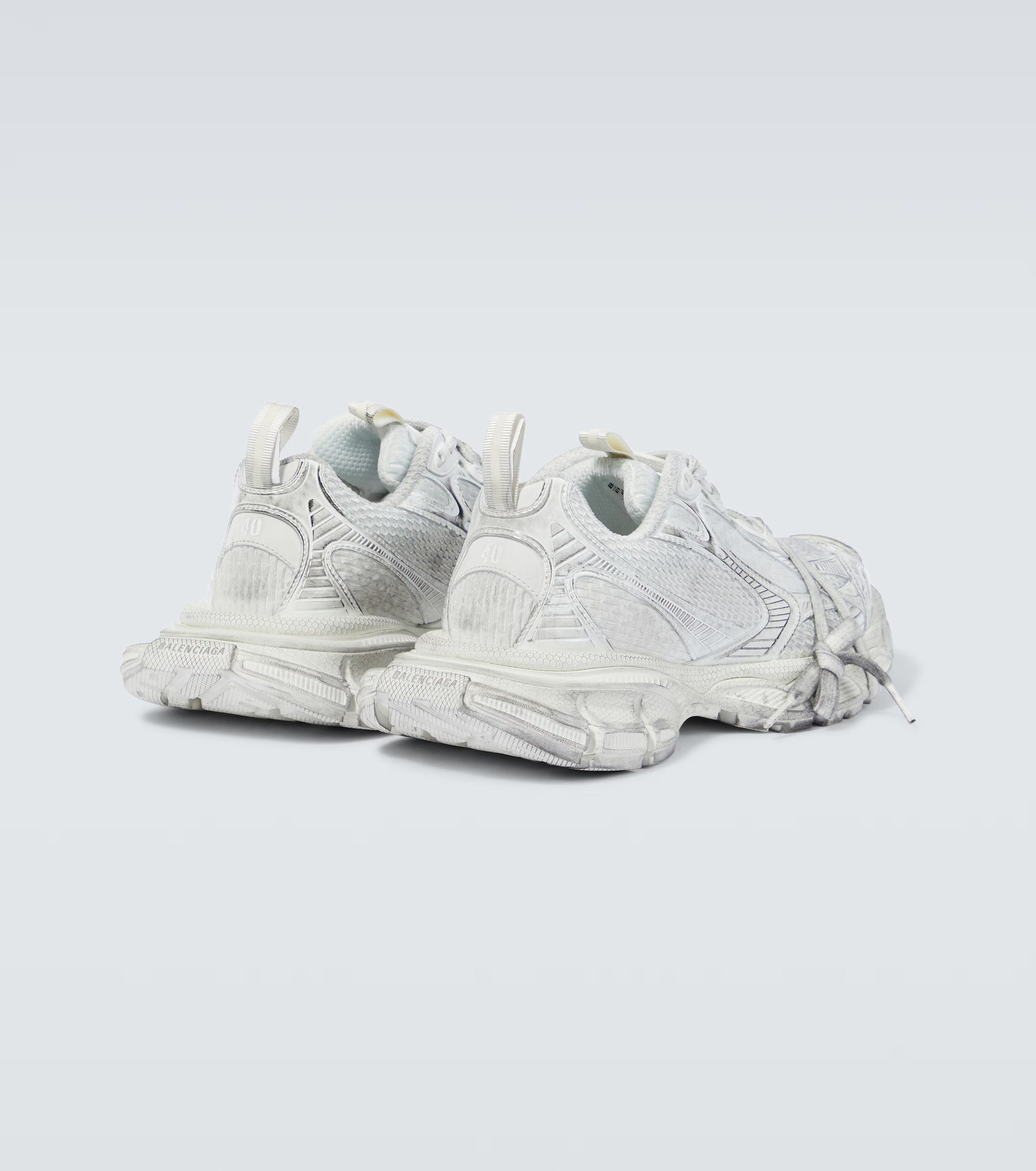 white grey 3XL oversized sneakers

chunky brutalist sneakers with mesh upper

trail running inspired tech footwear

balenciaga style extra large sneakers