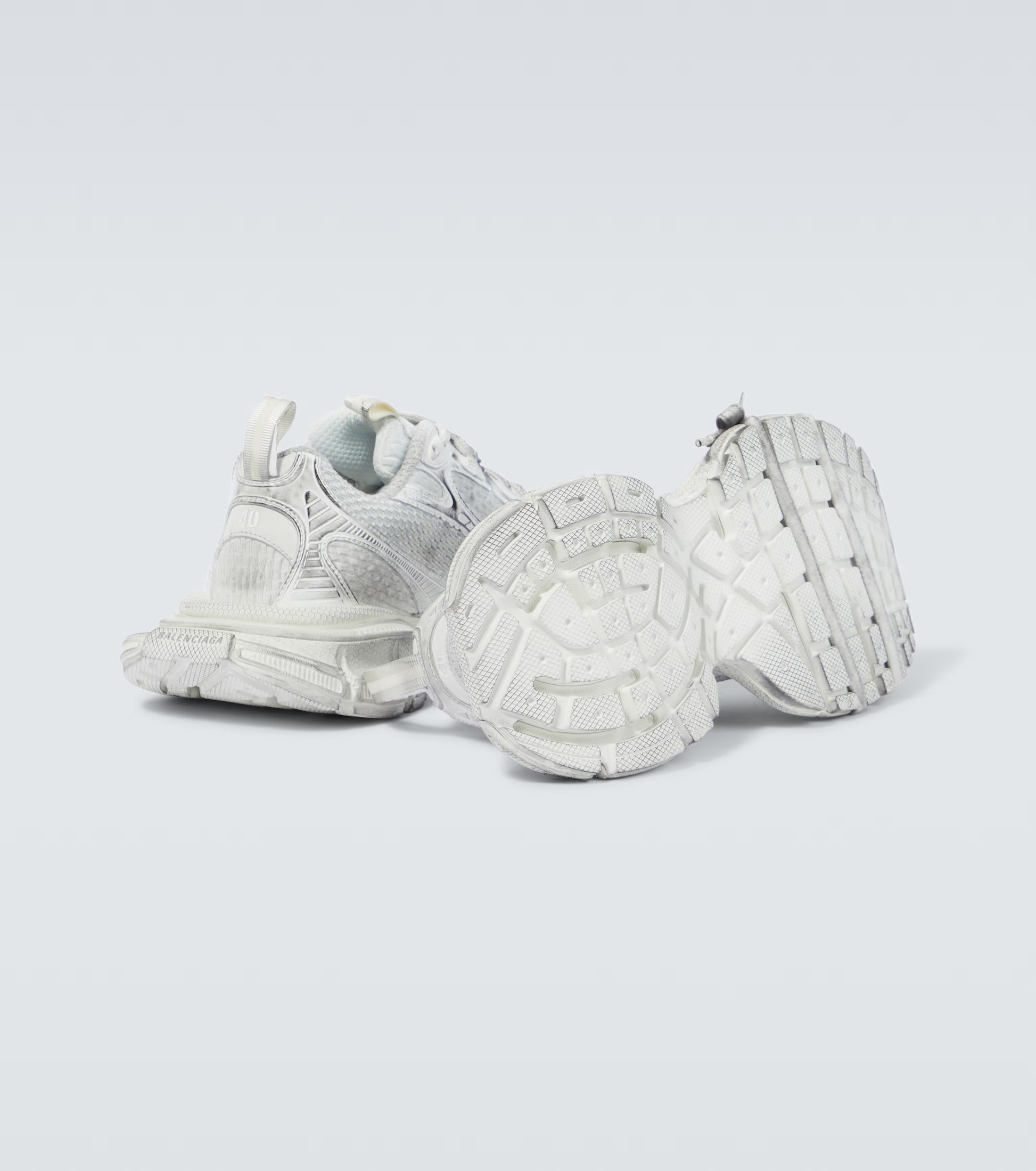 white grey 3XL oversized sneakers

chunky brutalist sneakers with mesh upper

trail running inspired tech footwear

balenciaga style extra large sneakers